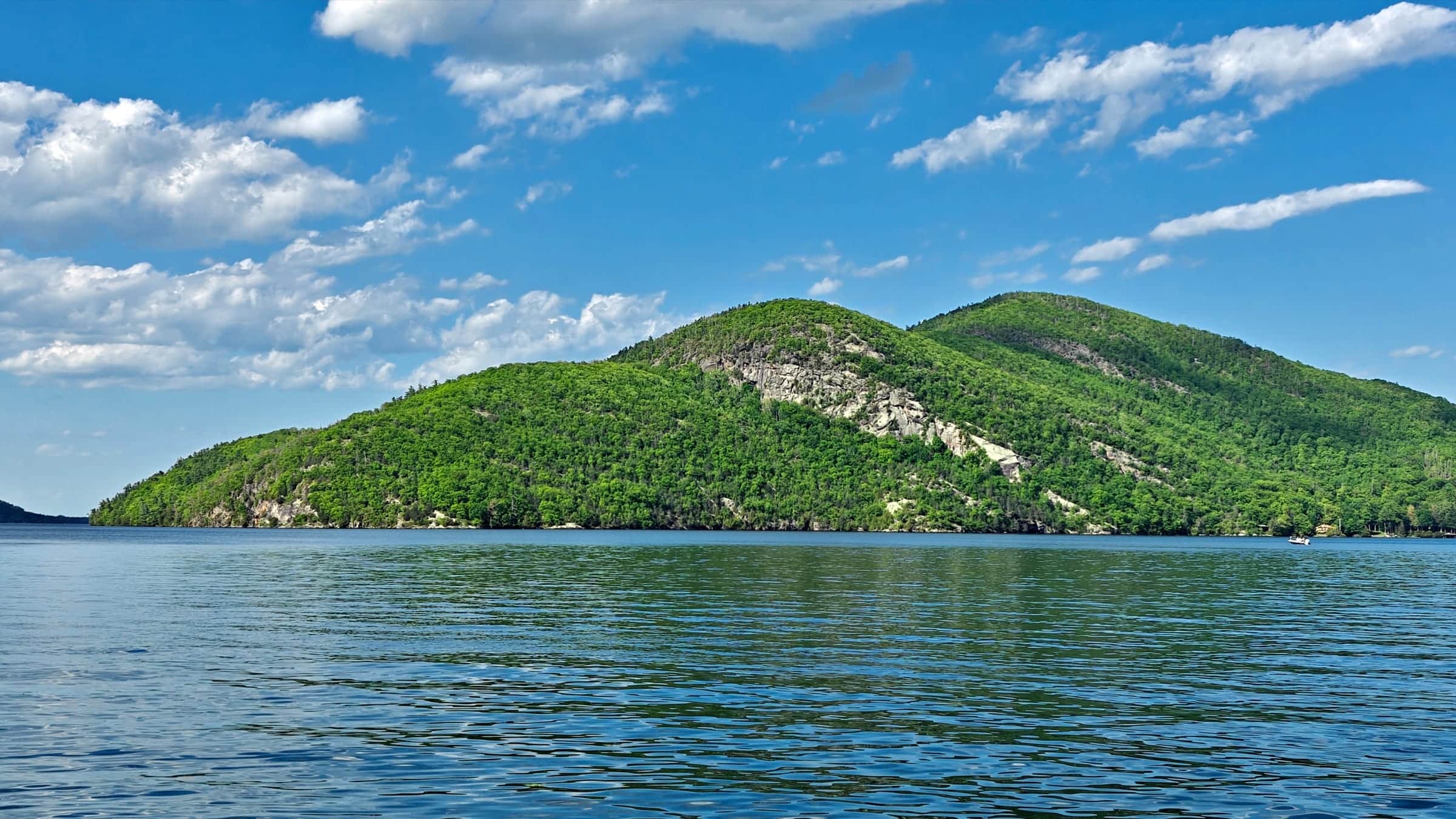 Lake George water with Adirondack mountains and clouds